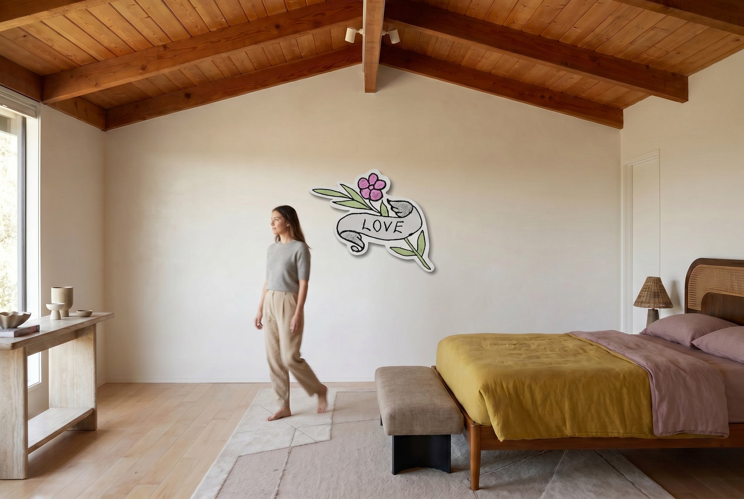 LOVE shaped canvas by Life Without on a bedroom wall beneath exposed wood beams