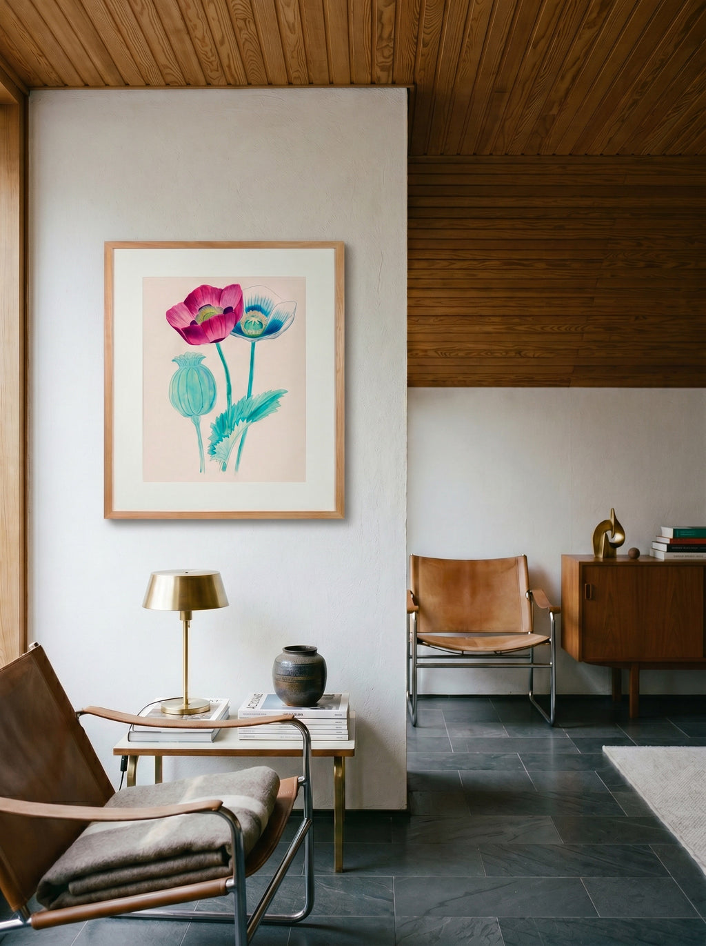 Opium Poppy framed botanical print by Life Without hanging in a mid-century sitting room with leather sling chairs